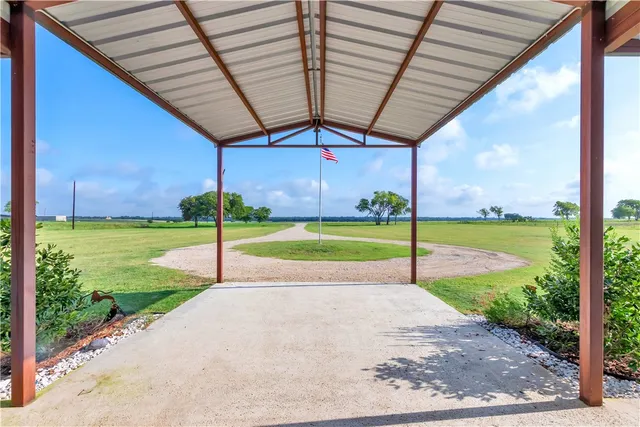 a view of a big yard with table and chairs