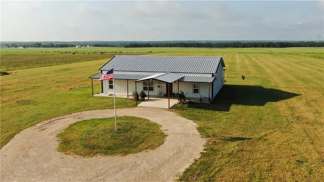 a swimming pool with outdoor seating and yard