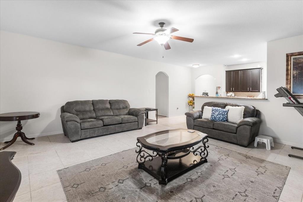 2529 Spring Meadows Drive Denton, TX 76209 - Photo 11 of 29 a living room with furniture and a flat screen tv