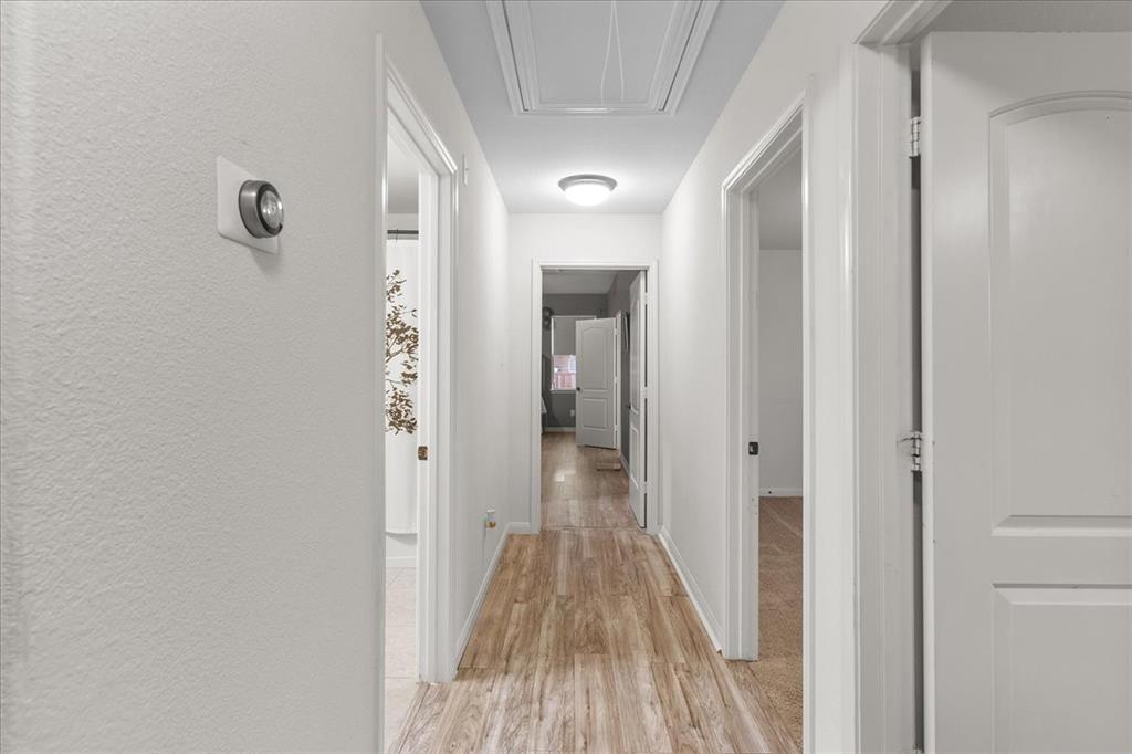 2529 Spring Meadows Drive Denton, TX 76209 - Photo 14 of 29 a view of a hallway with wooden floor