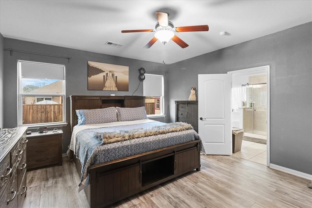 2529 Spring Meadows Drive Denton, TX 76209 - Photo 16 of 29 a bedroom with a bed and a painting on the wall