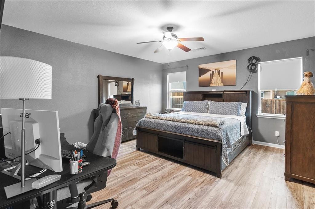 2529 Spring Meadows Drive Denton, TX 76209 - Photo 17 of 29 a bedroom with a bed and wooden floor