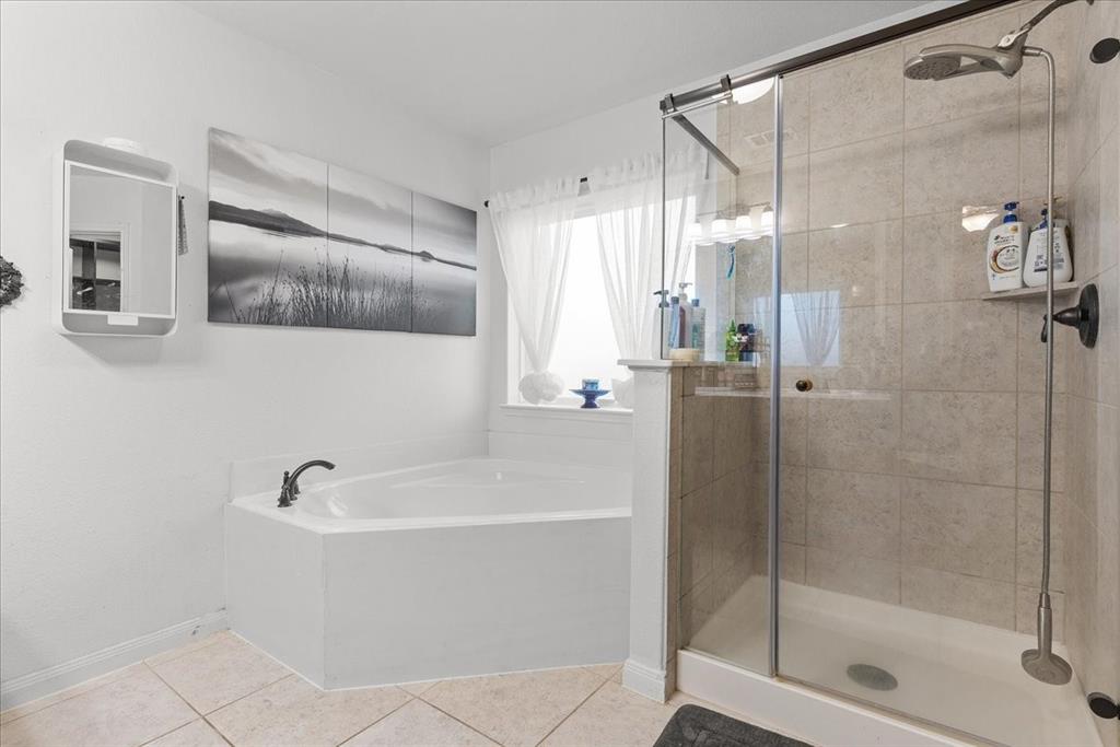 2529 Spring Meadows Drive Denton, TX 76209 - Photo 20 of 29 a white bath tub sitting next to a shower