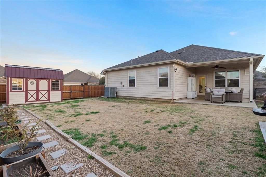 2529 Spring Meadows Drive Denton, TX 76209 - Photo 27 of 29 a view of a house with a backyard and windows