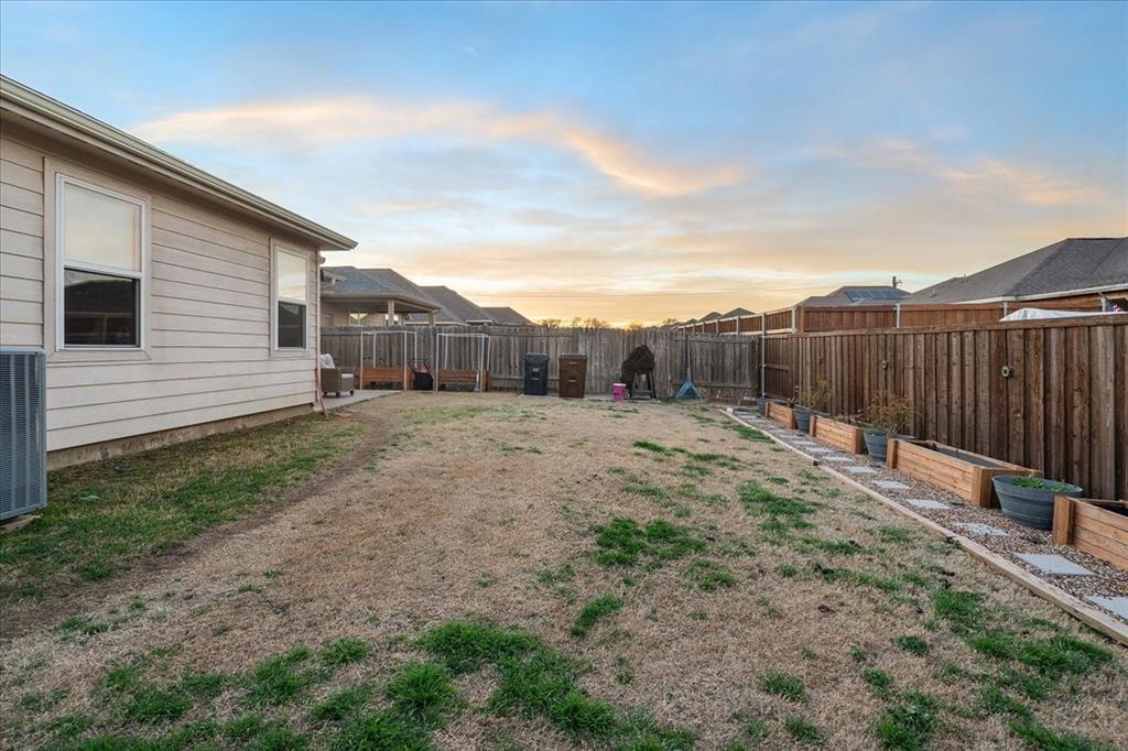 2529 Spring Meadows Drive Denton, TX 76209 - Photo 29 of 29 a backyard of a house with lots of green space
