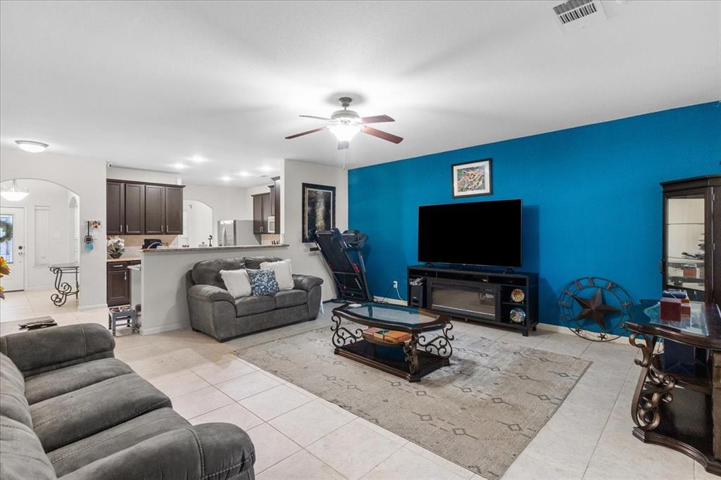 2529 Spring Meadows Drive Denton, TX 76209 - Photo 8 of 29 a living room with furniture and a flat screen tv