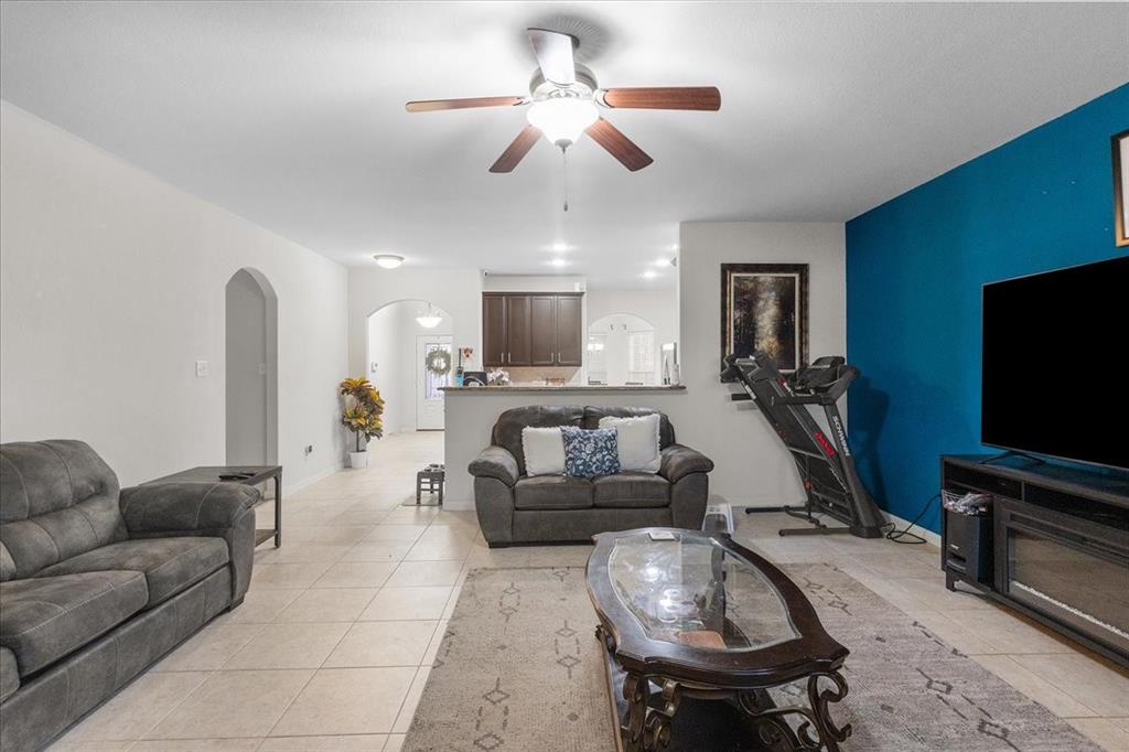 2529 Spring Meadows Drive Denton, TX 76209 - Photo 9 of 29 a living room with furniture and a flat screen tv