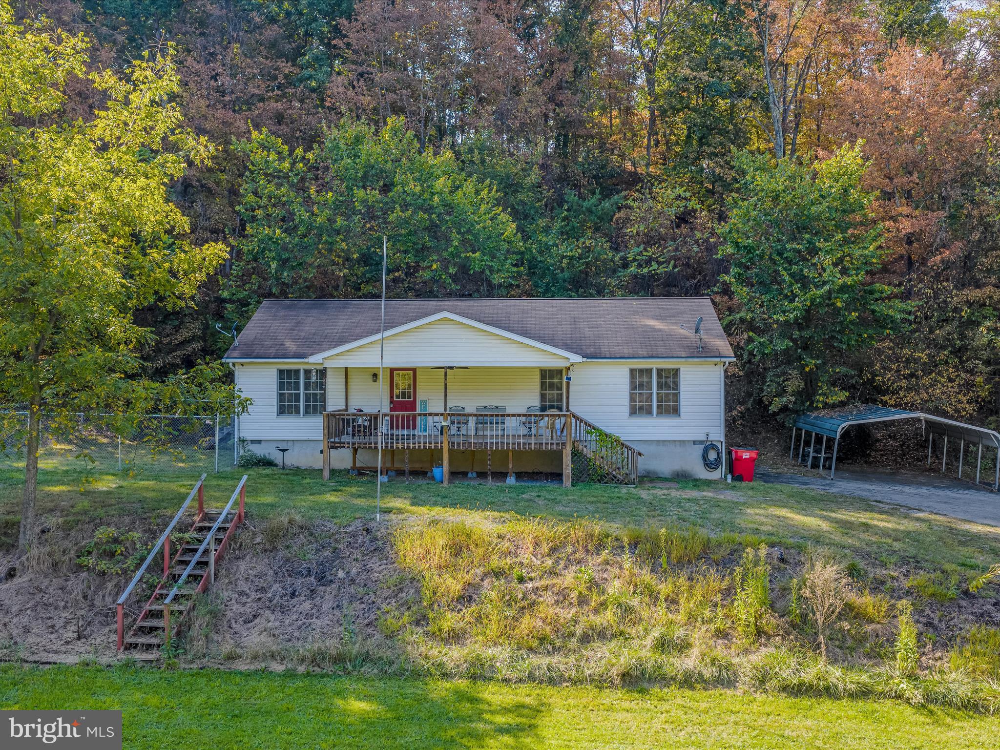 84 New Hope Road Berkeley Springs, WV 25411 - Photo 1 of 28 a front view of a house with garden