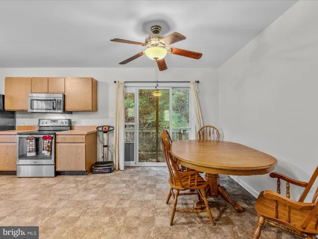 a view of a dining room with furniture and a window