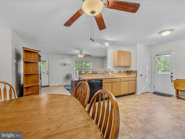 a kitchen with stainless steel appliances granite countertop a sink a stove and refrigerator