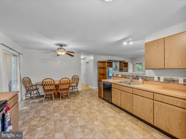 a large kitchen with a table and chairs