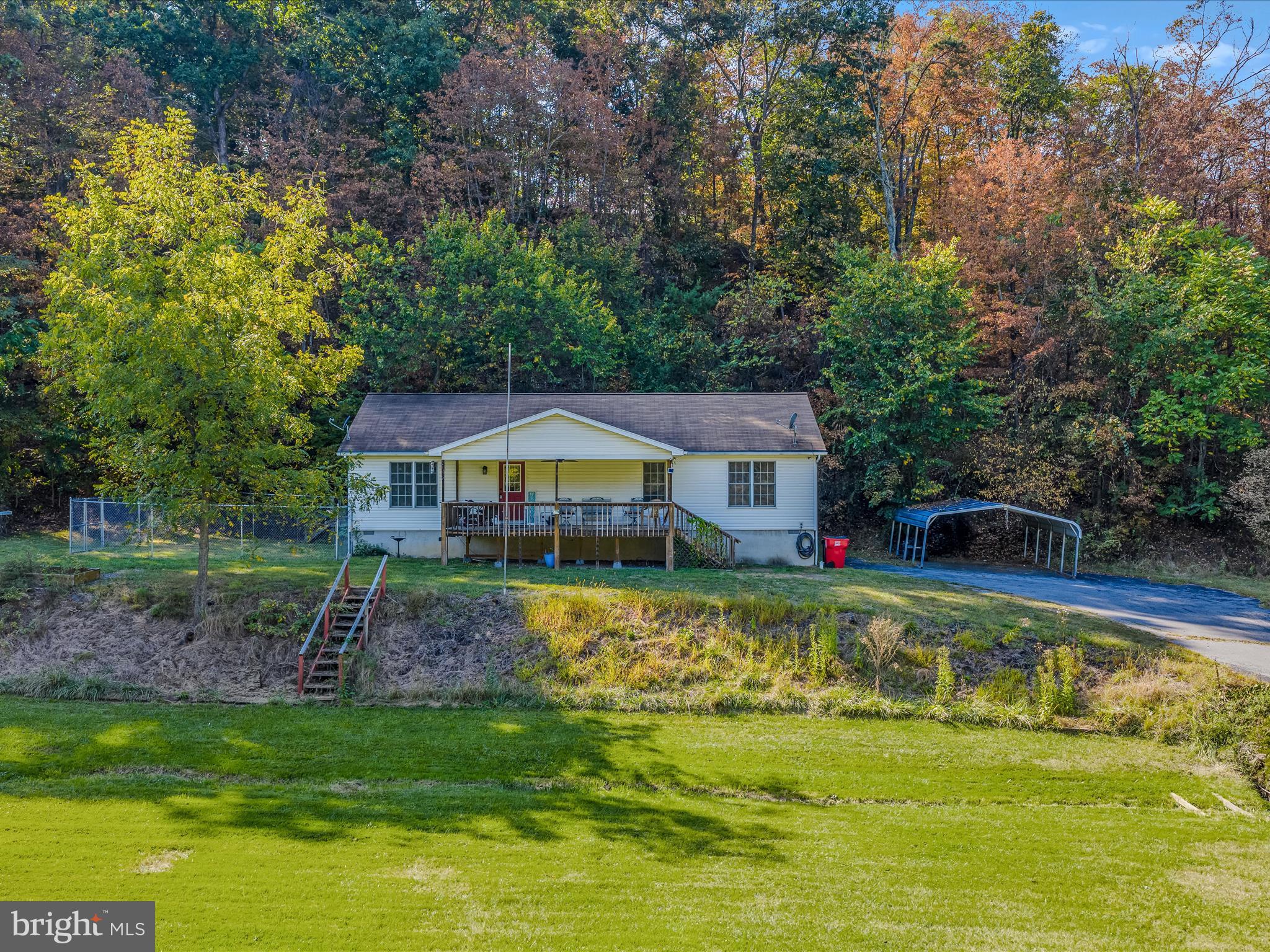 84 New Hope Road Berkeley Springs, WV 25411 - Photo 2 of 28 a front view of a house with swimming pool having outdoor seating
