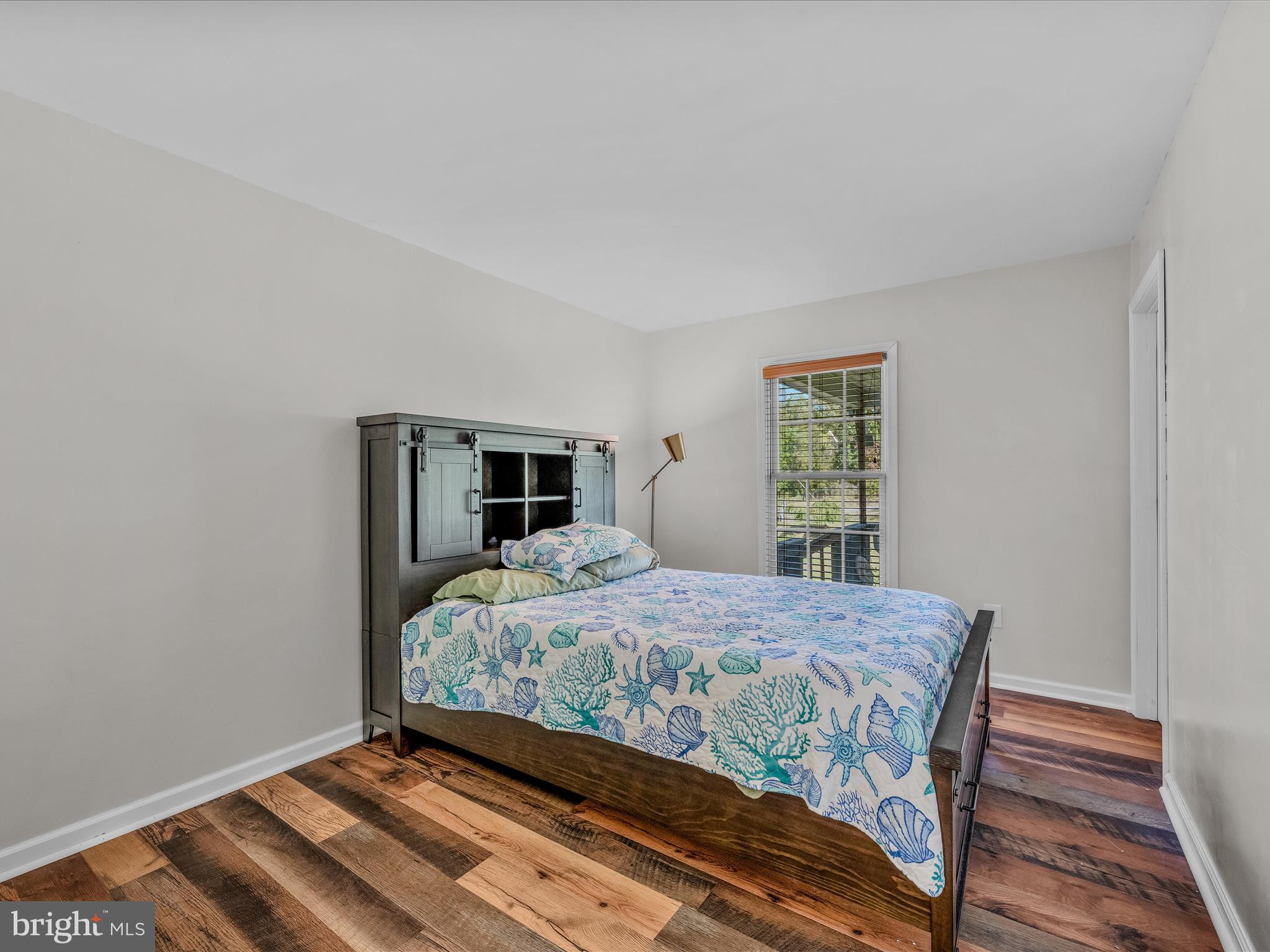 84 New Hope Road Berkeley Springs, WV 25411 - Photo 21 of 28 a bedroom with a bed and a window