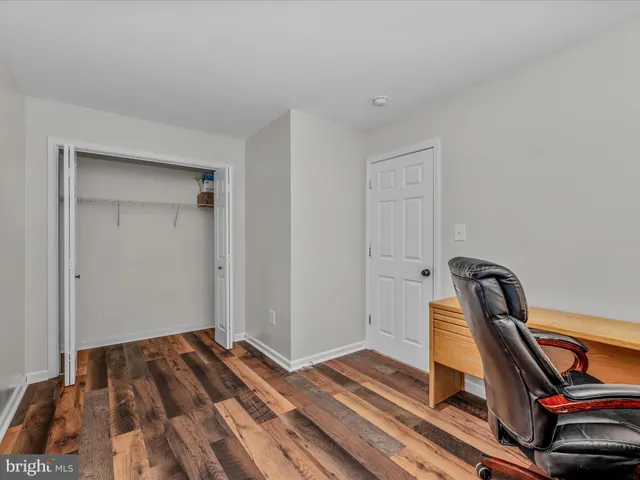 a view of a bedroom with wooden floor and air conditioner