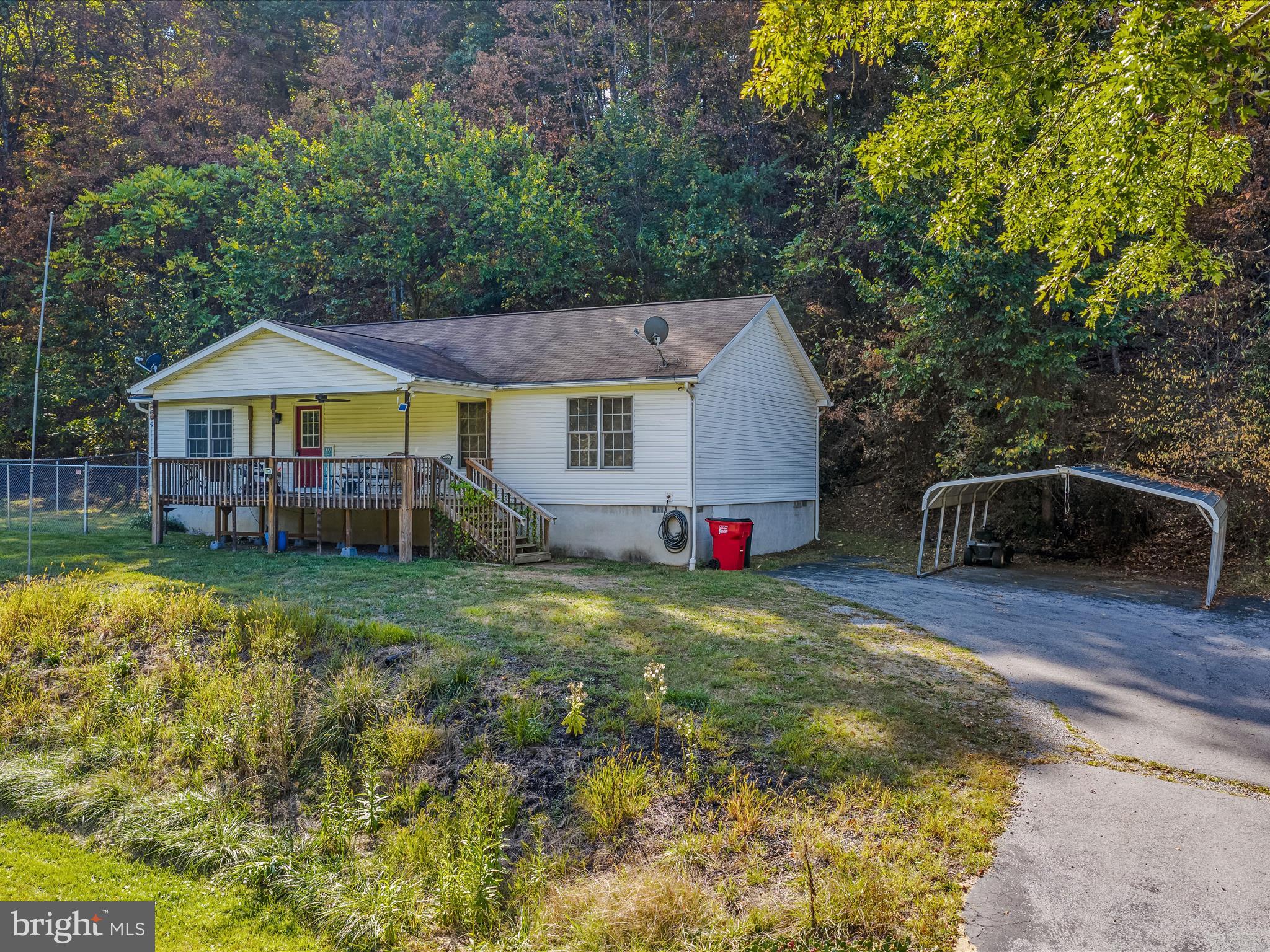 84 New Hope Road Berkeley Springs, WV 25411 - Photo 3 of 28 a view of a house with a yard patio and sitting area
