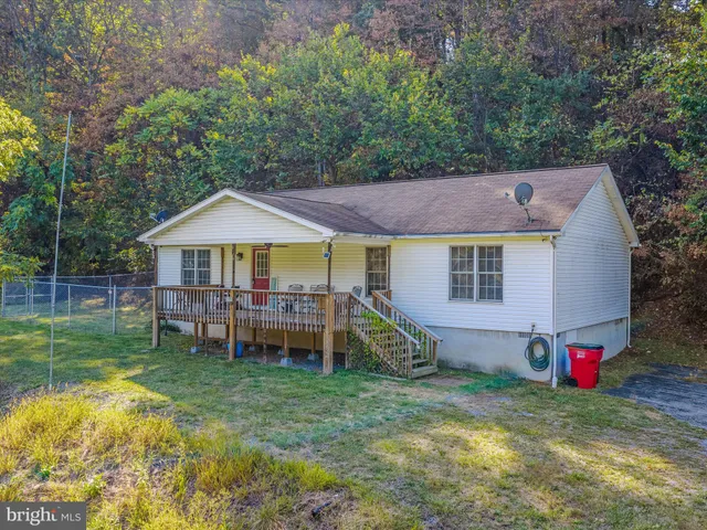 a view of a house with a yard and sitting area