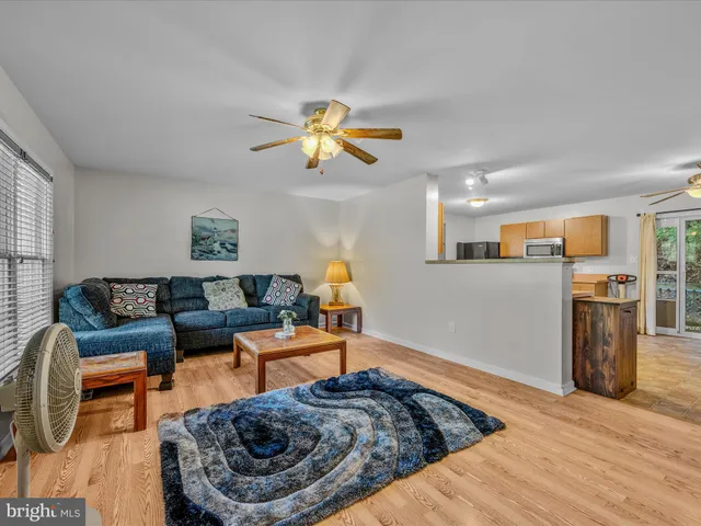a living room with furniture and kitchen view
