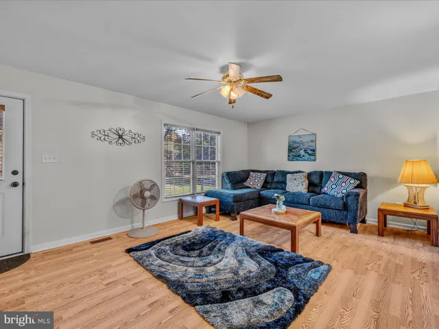 a living room with furniture rug and window