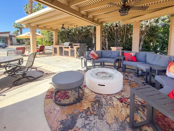 a view of a patio with a dining table and chairs