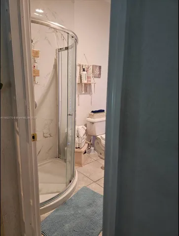 a bathroom with a glass shower door