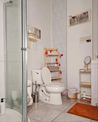 a bathroom with a toilet and a shower