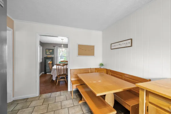 a room with pool table and chairs