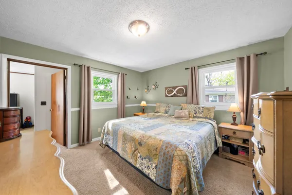 a bedroom with a bed and a couch