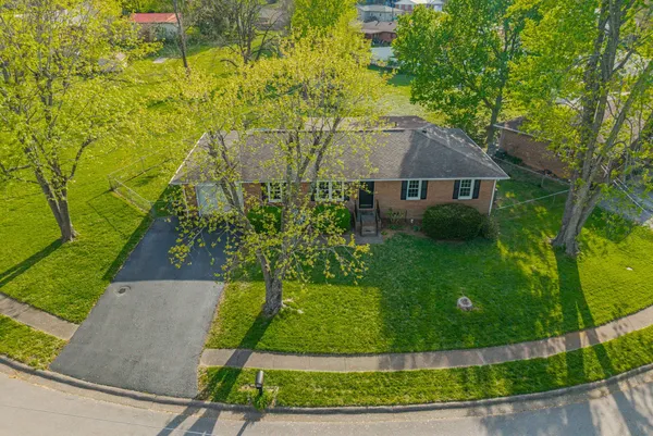 an aerial view of a house with a yard