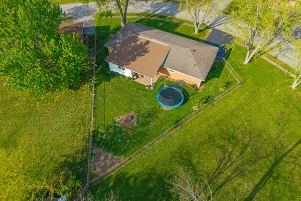 an aerial view of a house with yard swimming pool and outdoor seating