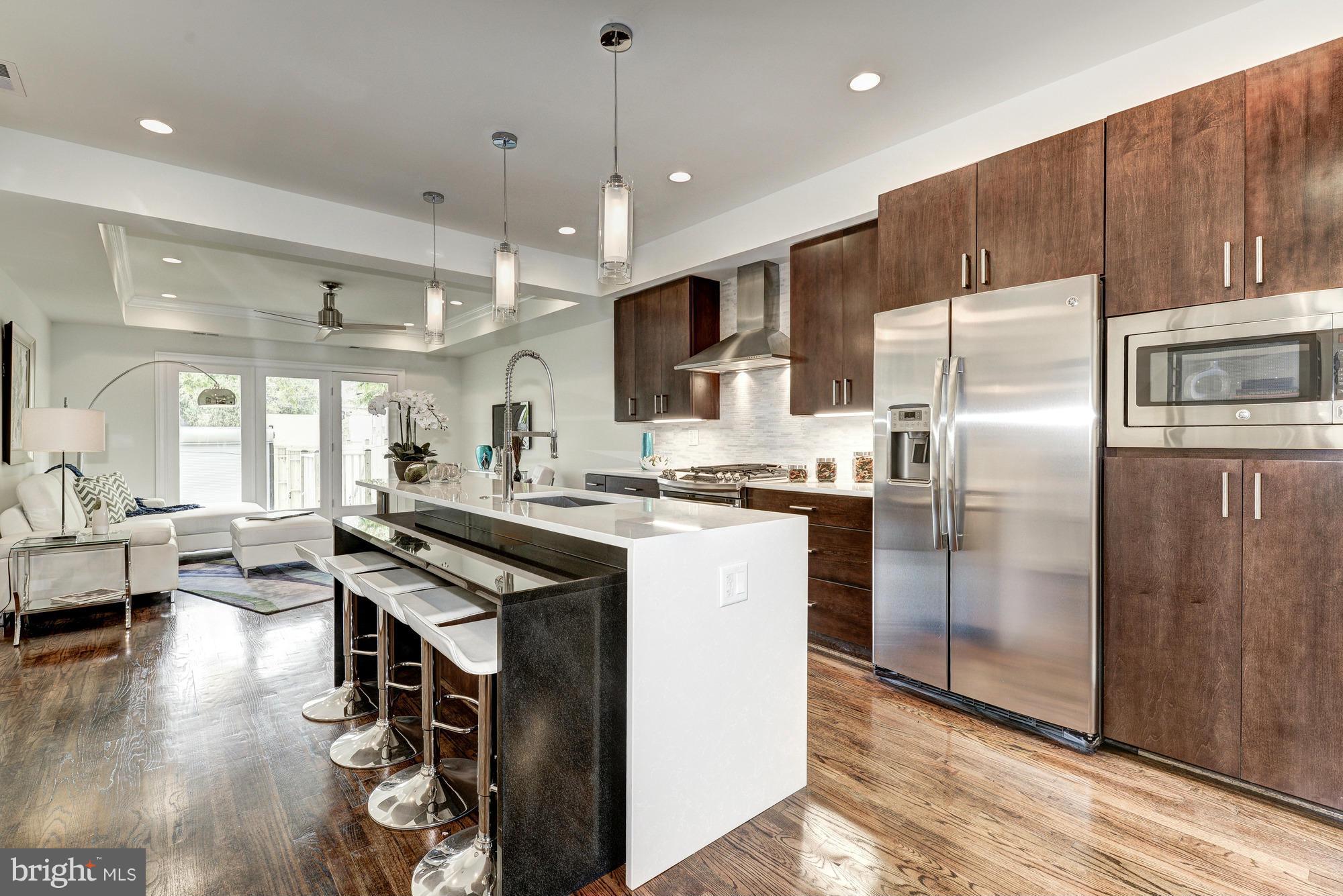 536 14th Street Southeast Washington, DC 20003 - Photo 1 of 25 a kitchen with stainless steel appliances granite countertop a refrigerator a sink dishwasher a stove and a refrigerator with wooden floor