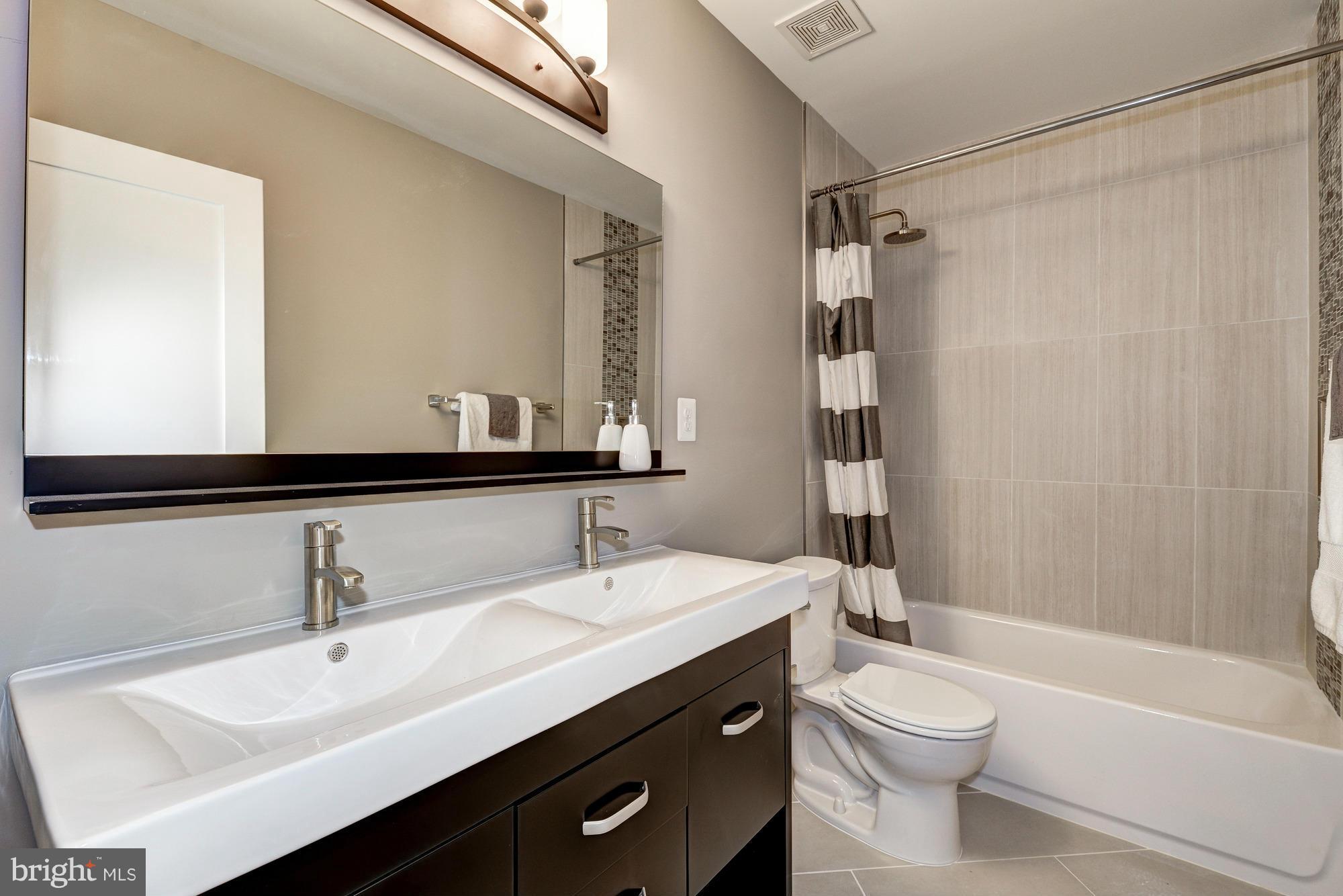536 14th Street Southeast Washington, DC 20003 - Photo 14 of 25 a bathroom with a sink a toilet and shower