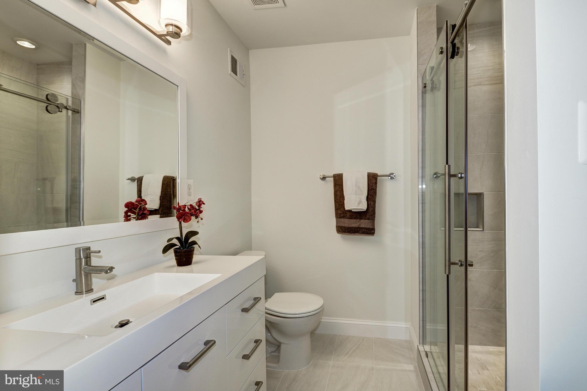 536 14th Street Southeast Washington, DC 20003 - Photo 18 of 25 a bathroom with a sink toilet and shower