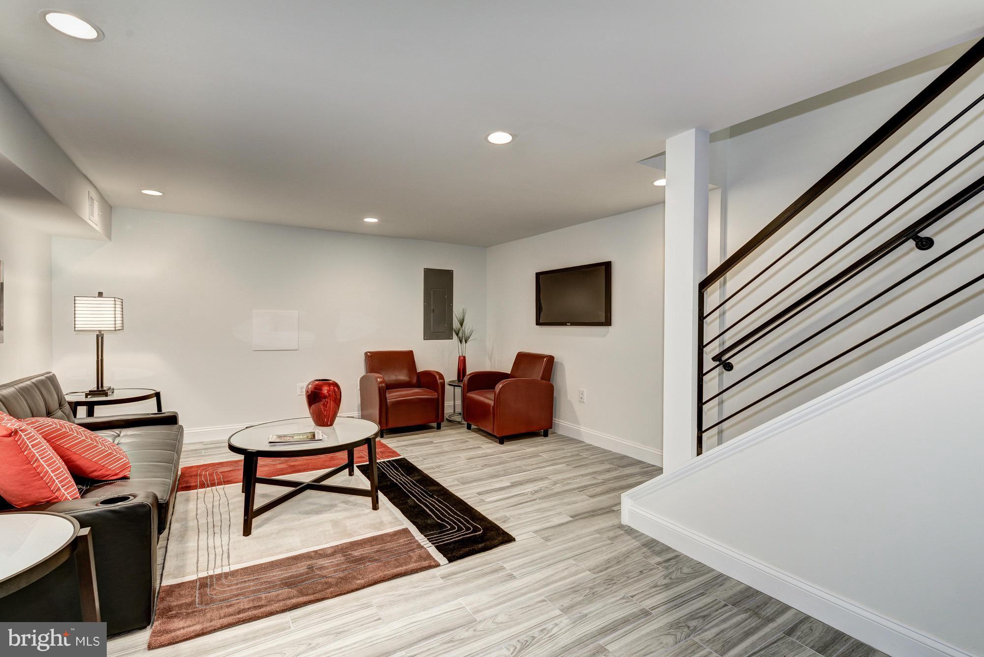 536 14th Street Southeast Washington, DC 20003 - Photo 22 of 25 a living room with furniture and a wooden floor