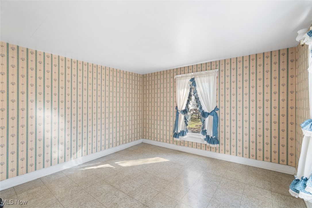 10719 Navarre Road Southwest Navarre, OH 44662 - Photo 27 of 36 Bedroom with wallpapered walls, tile patterned floors, and baseboards