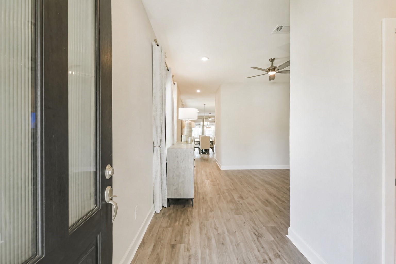 15611 Rising Wren Court Conroe, TX 77302 - Photo 4 of 38 a view of a hallway with a wooden floor