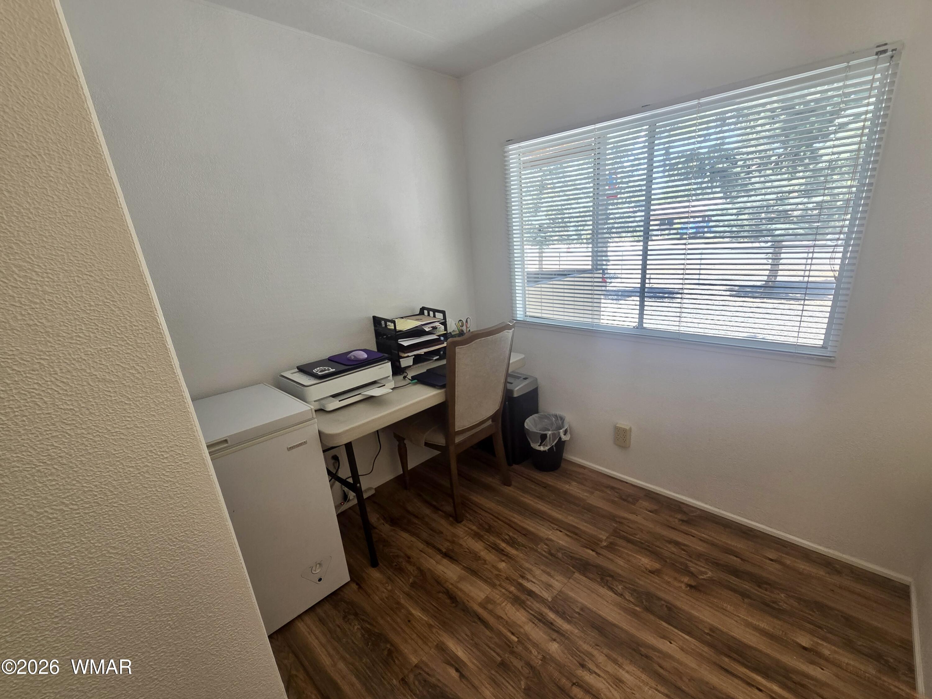 727 South Butler Street Eagar, AZ 85925 - Photo 23 of 32 a room with wooden floor and a window
