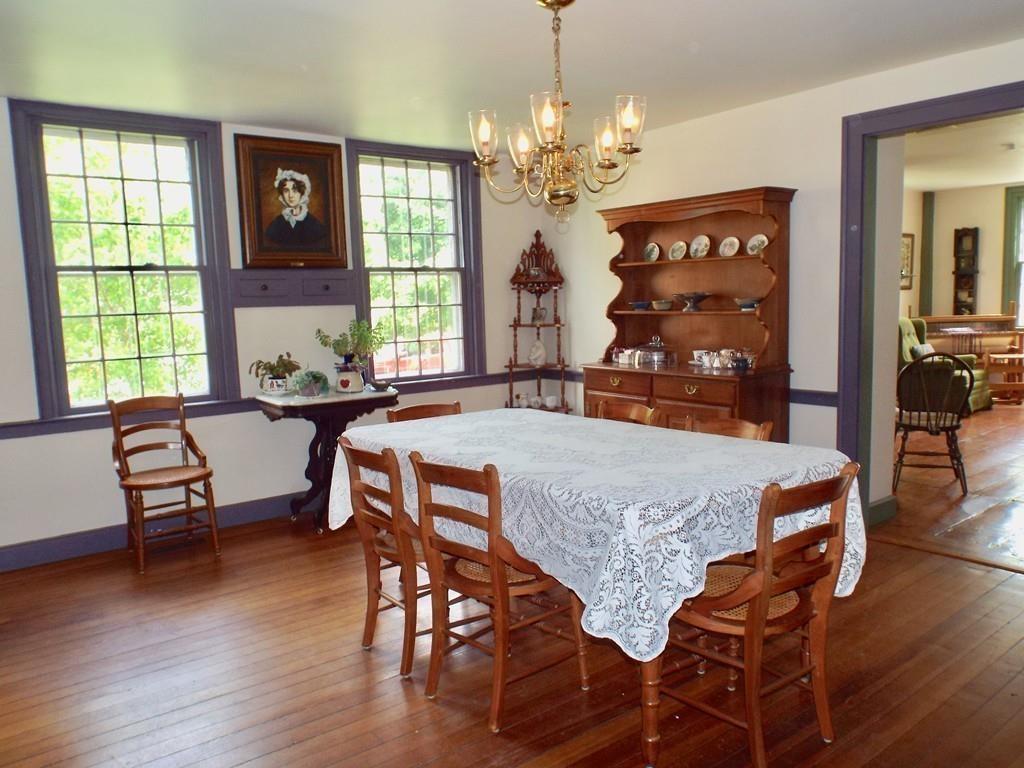 2 Charlemont Road Buckland, MA 01338 - Photo 15 of 42 a dining room with wooden floor a chandelier a wooden table and chairs