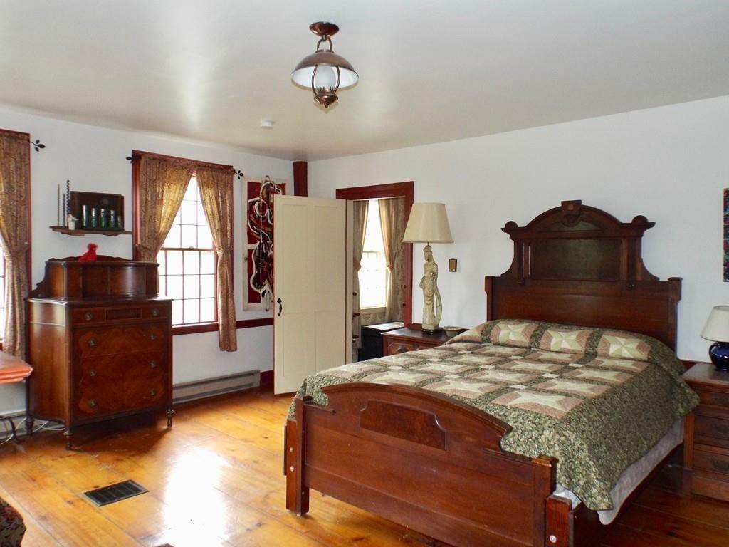 2 Charlemont Road Buckland, MA 01338 - Photo 22 of 42 a bedroom with a bed and wooden floor