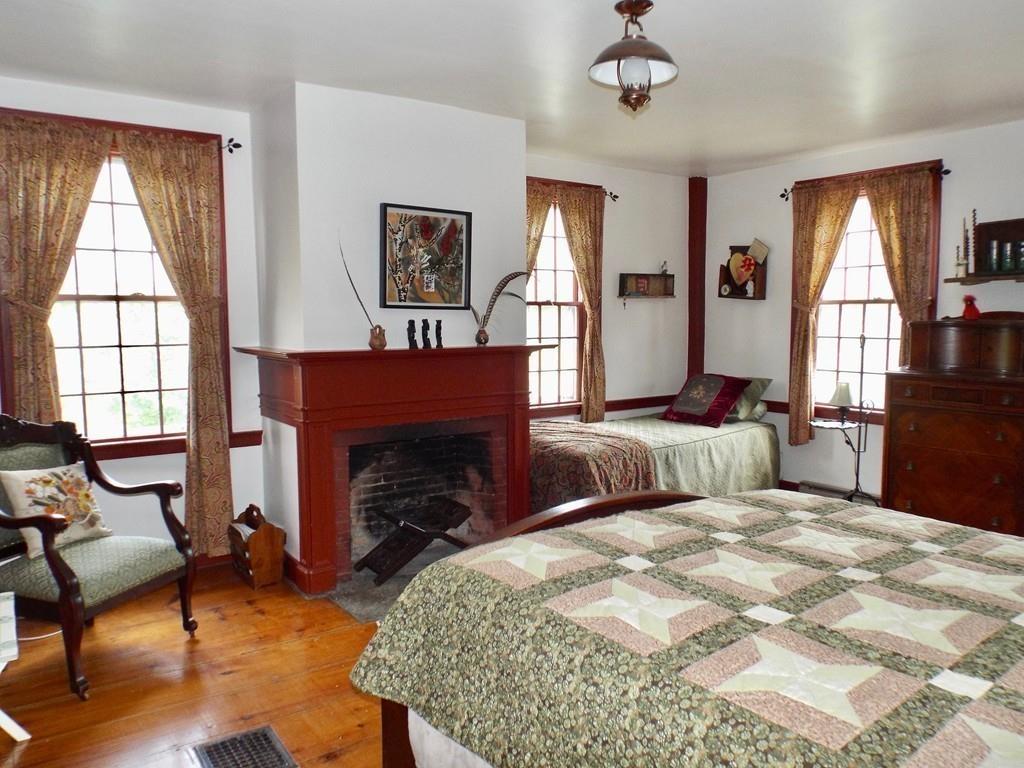 2 Charlemont Road Buckland, MA 01338 - Photo 23 of 42 a bedroom with a bed a fireplace and a large mirror