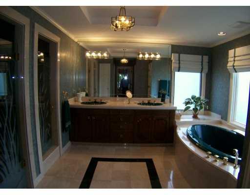 63 North River Road Stuart, FL 34996 - Photo 6 of 8 a bathroom with a sink a large mirror and a shower