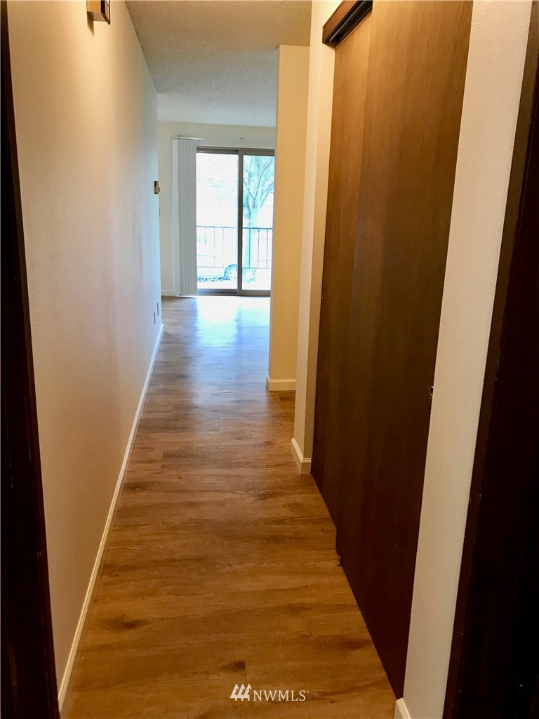 3912 Linden Avenue North Seattle, WA 98103 - Photo 5 of 11 a view of a hallway with wooden floor