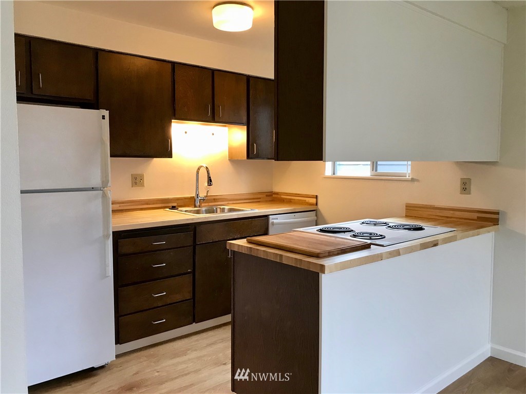 3912 Linden Avenue North Seattle, WA 98103 - Photo 7 of 11 a kitchen with a stove and a refrigerator