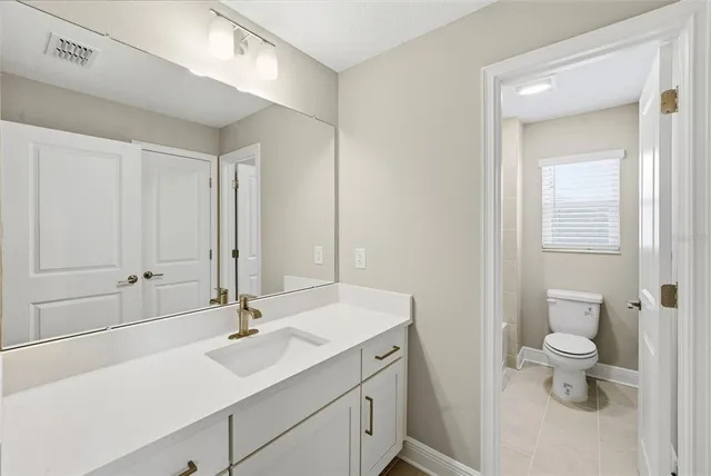 a bathroom with a toilet a sink and bath tub