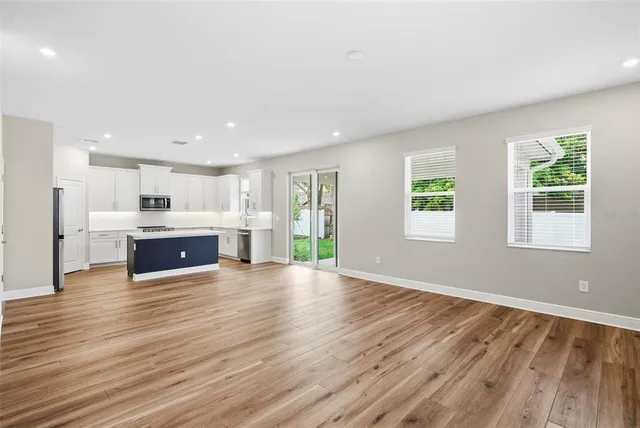 a view of kitchen with wooden floor and windows