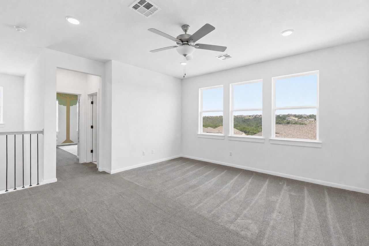 836 Villa Rialto View Leander, TX 78641 - Photo 26 of 33 A well-lit bonus room offers elevated views and versatile living space.