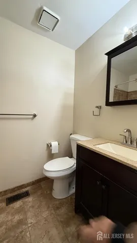 a bathroom with a sink toilet and mirror