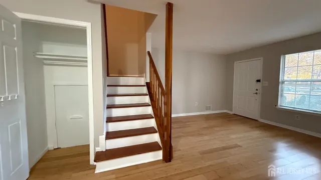 a view of entryway with wooden floor and stairs