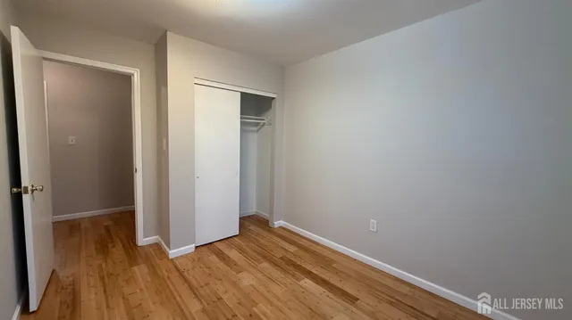 a view of room with wooden floor