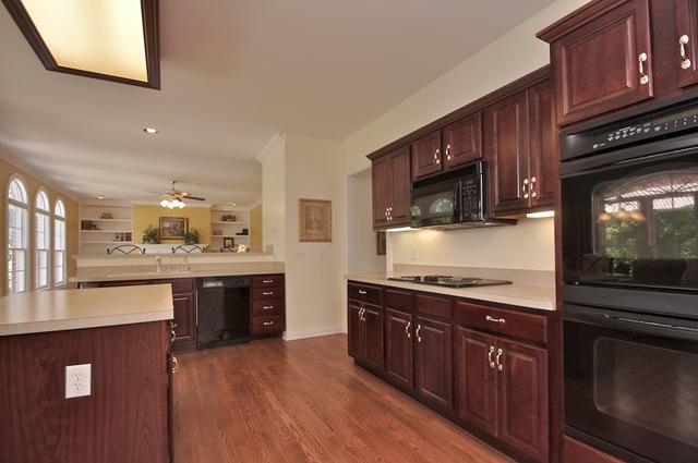 428 Doe Ridge Franklin, TN 37067 - Photo 5 of 20 Cherry cabinets add a opulant feeling to the atmosphere that it the kitchen.