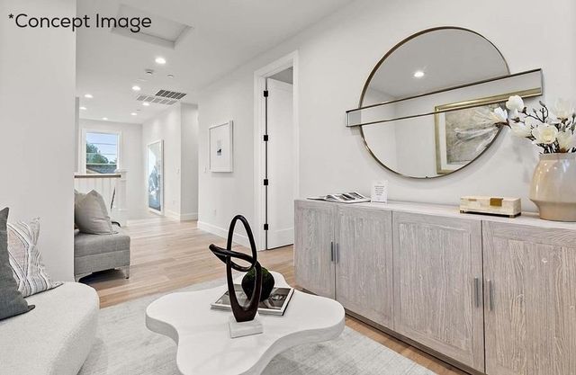 a view of a livingroom with furniture and mirror